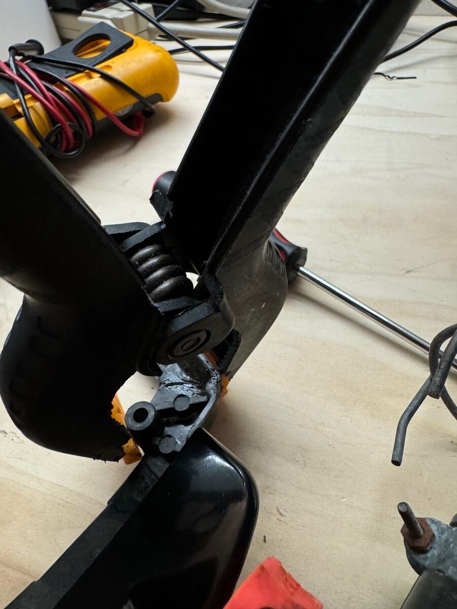 A clamp holding together a bakelite base as JB Weld cures. 